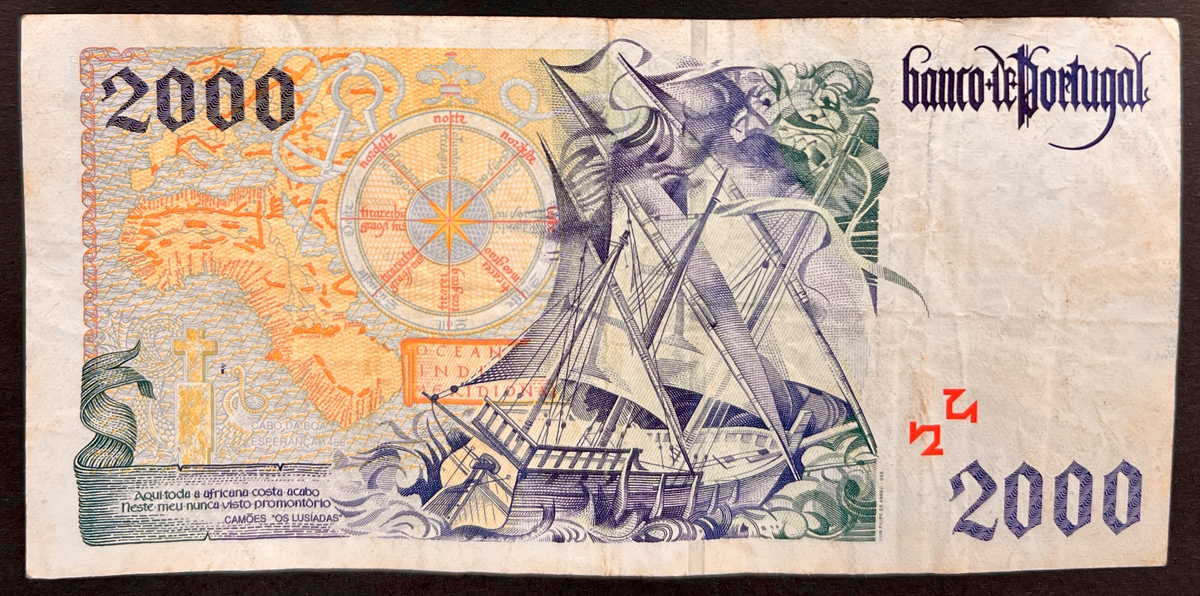 Back view of a vintage 1995 Portugal 2000 Escudos banknote showcasing a detailed engraving of a Portuguese caravel sailing ship navigating rough seas next to a map of Africa.