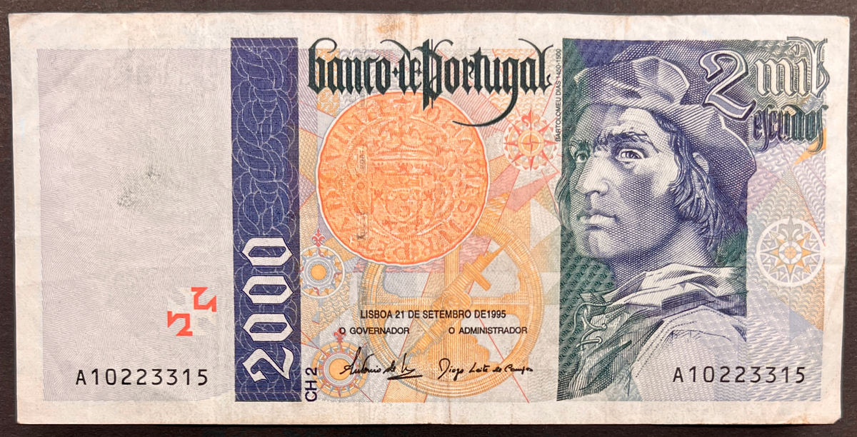Front view of a circulated 1995 Portugal 2000 Escudos banknote featuring a portrait of explorer Bartolomeu Dias, a navigational astrolabe, and a vintage Cruzado coin.