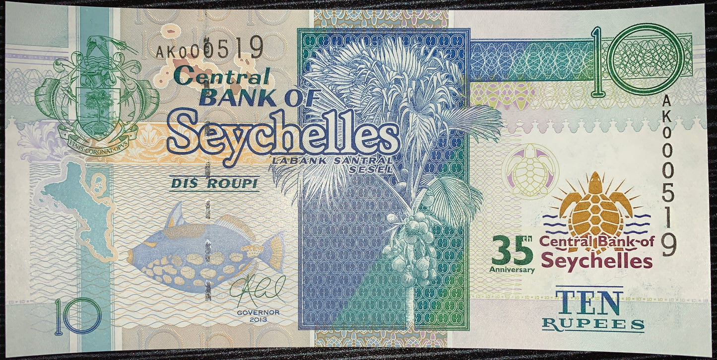 front of Seychelles 10 Rupees 2013 P-46 UNC Commemorative Banknote collectible modern banknote with Clownfish and  Coco-de-mer Palm