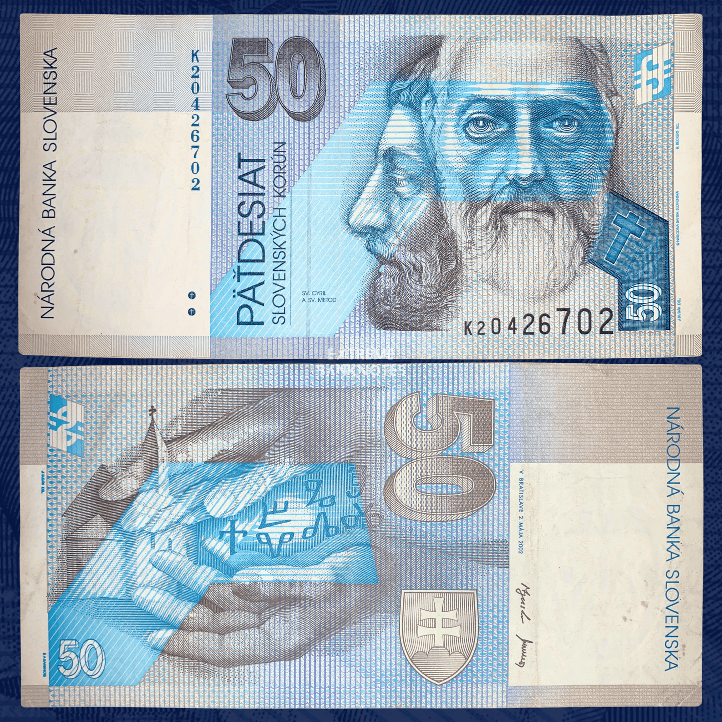 Front and reverse views of a Slovakia 50 Korún banknote (P-21d) issued by Národná Banka Slovenska in 2002. The obverse features Saints Cyril and Methodius in blue and gray tones, with denomination numerals, Slovak inscriptions, and serial number K20426702. The reverse depicts symbolic hands holding a manuscript with Glagolitic script, a church tower, and the Slovak coat of arms. The circulated banknote displays visible folds, creases, and light staining from handling. Actual serial numbers may vary as multi