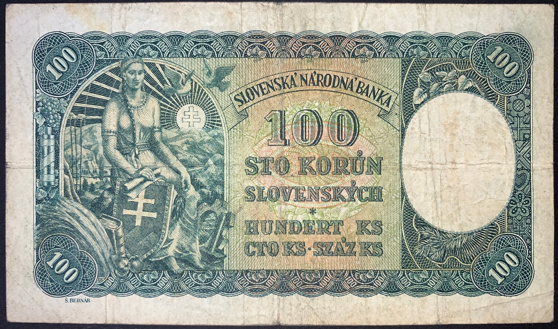 Slovakia 100 Korún 1940 banknote (P-10) reverse depicting an allegorical female figure seated with the Slovak coat of arms shield, mountain landscape, rising sun, doves, and ornate engraved borders. Detailed blue-green design with multilingual denomination text and classic European banknote artistry.
