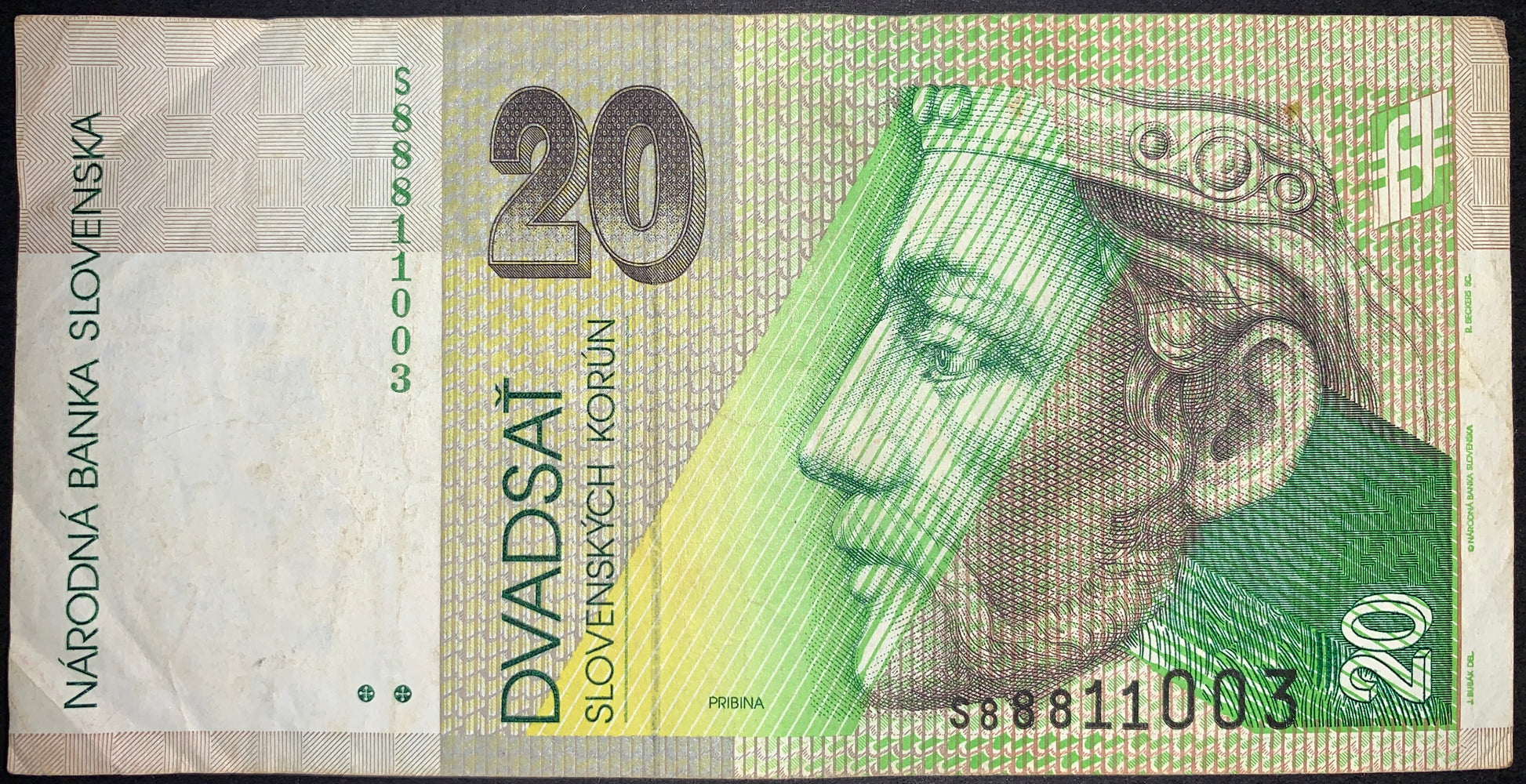 Authentic Slovakia 20 korún banknote featuring Prince Pribina, a 9th-century ruler associated with the earliest Slovak state formations. Green and yellow design with intricate security patterns, serial number, and Národná banka Slovenska inscriptions.