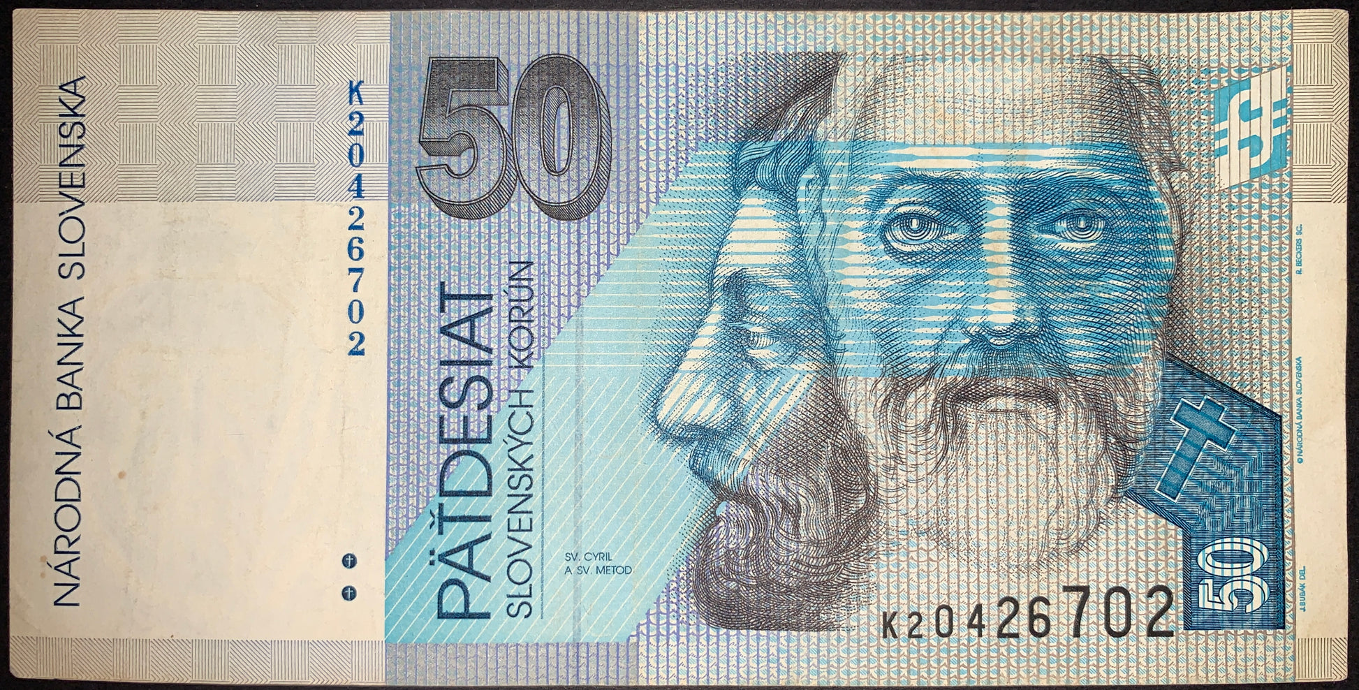 Authentic Slovakia 50 korún banknote featuring Saints Cyril and Methodius, Byzantine missionaries credited with bringing Christianity and the Glagolitic script to the Slavic peoples. Blue-toned design with detailed portrait engraving and security features.