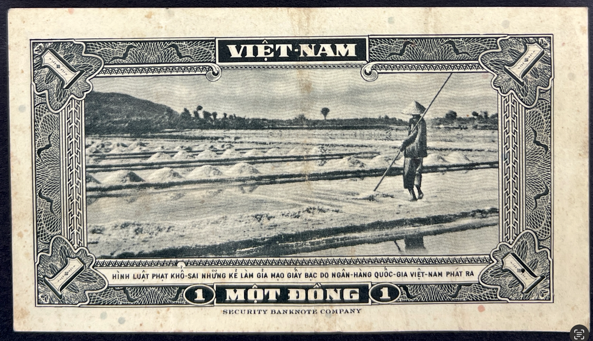 Back view of a vintage 1955 South Vietnam 1 Dong banknote showcasing a traditional scene of a farmer working in a coastal salt field.