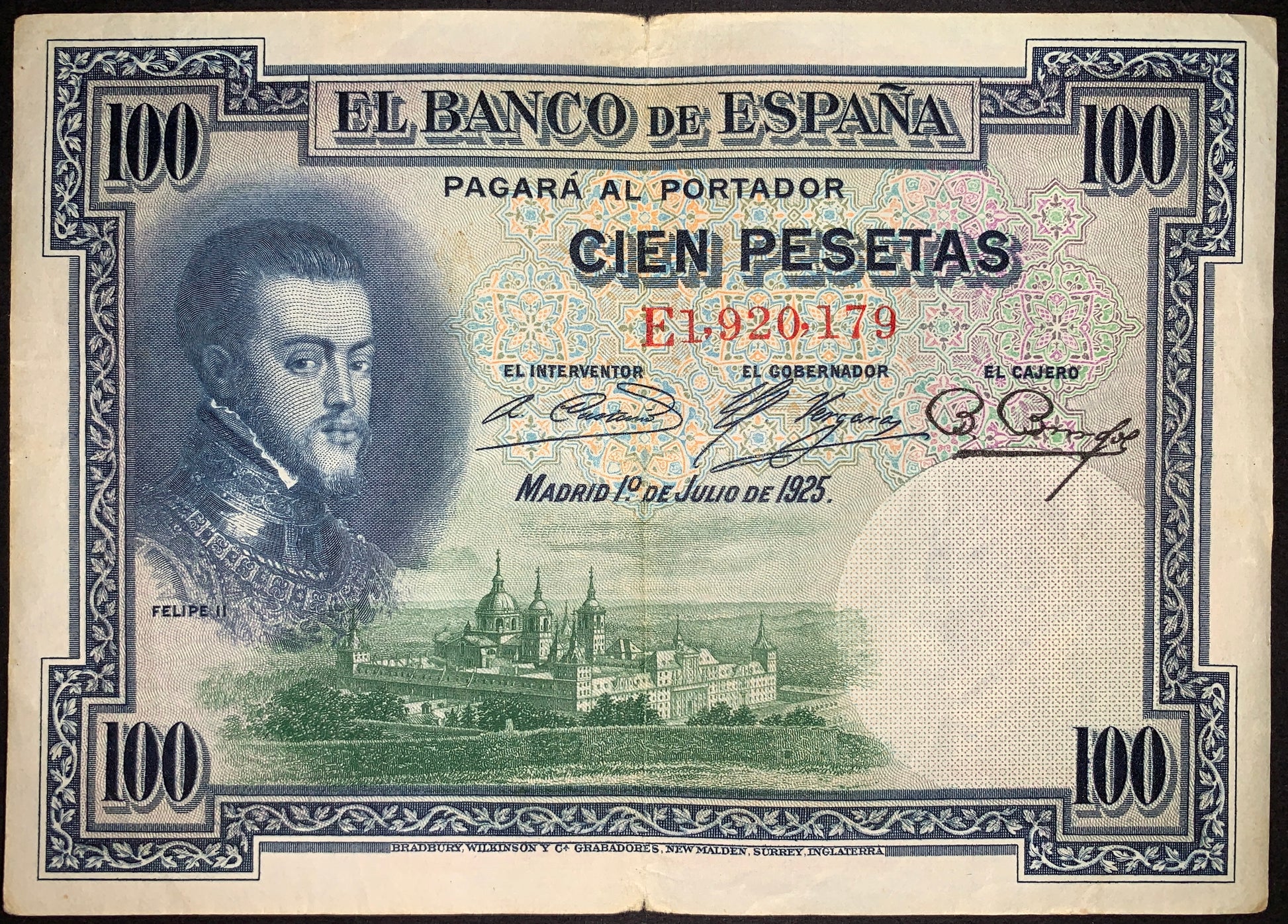 Spain 100 Pesetas banknote dated 1 July 1925 (P-69c) featuring a portrait of King Philip II, Banco de España inscriptions, and a detailed view of the Royal Monastery of San Lorenzo de El Escorial. Historic Spanish currency with green and blue engraved elements.