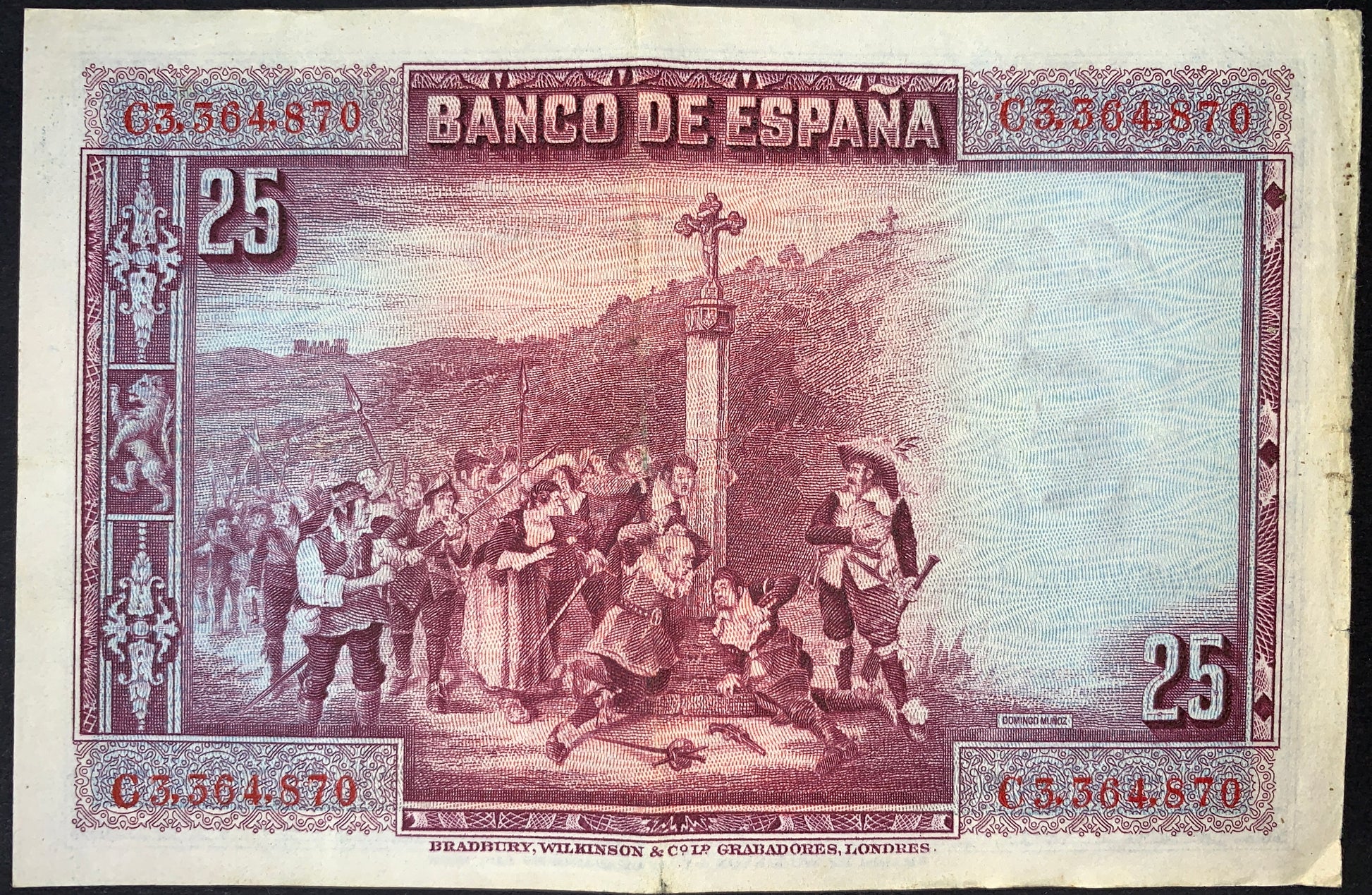 Reverse of Spain 25 Pesetas 1928 banknote (P-74) depicting a historical scene inspired by Spanish art, with figures gathered around a stone cross in a countryside setting. Detailed purple engraving with ornate decorative borders and denomination markings.