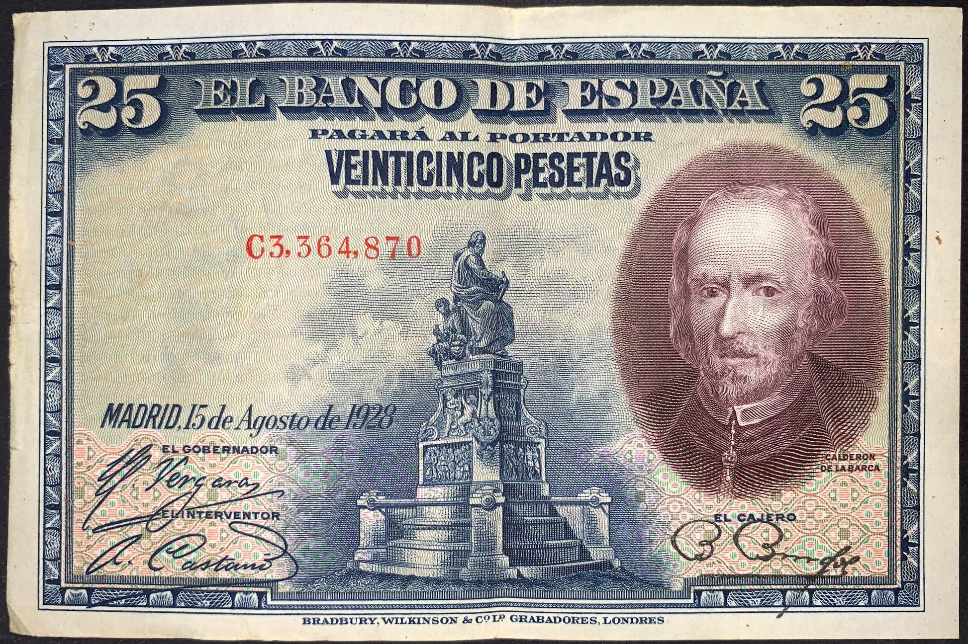 Spain 25 Pesetas banknote dated 15 August 1928 (P-74) issued by Banco de España, featuring a portrait of Fray Luis de León, ornate engraved borders, official signatures, and a central monument design. Historic Spanish currency with intricate blue and brown engraving.