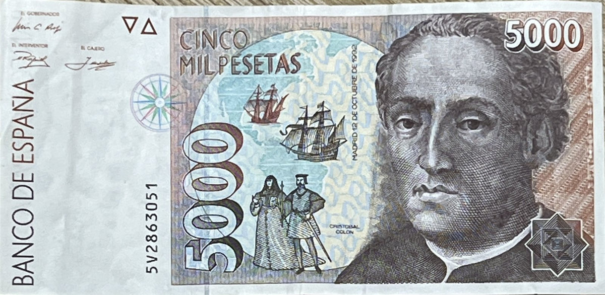 Front view of a circulated 1992 Spain 5000 Pesetas banknote featuring Christopher Columbus, two caravels over a map of the Americas and the Catholic Monarchs.