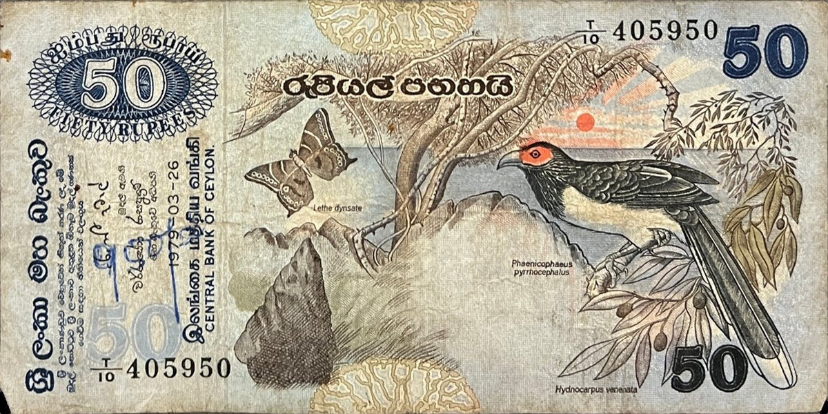 Front view of a circulated 1979 Ceylon (Sri Lanka) 50 Rupees banknote featuring a red-faced malkoha and a Ceylon forester butterfly.