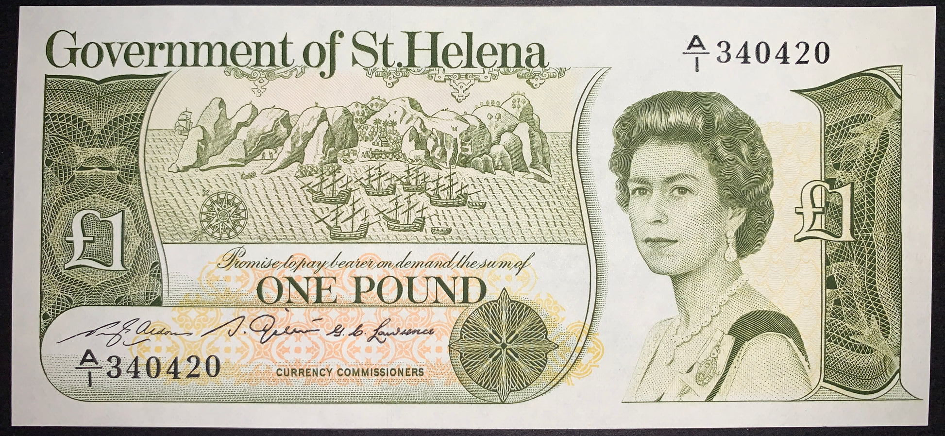 front of St. Helena 1 Pound ND (1981) P-9 AUNC featuring portrait of Queen Elizabeth II and the island of St. Helena