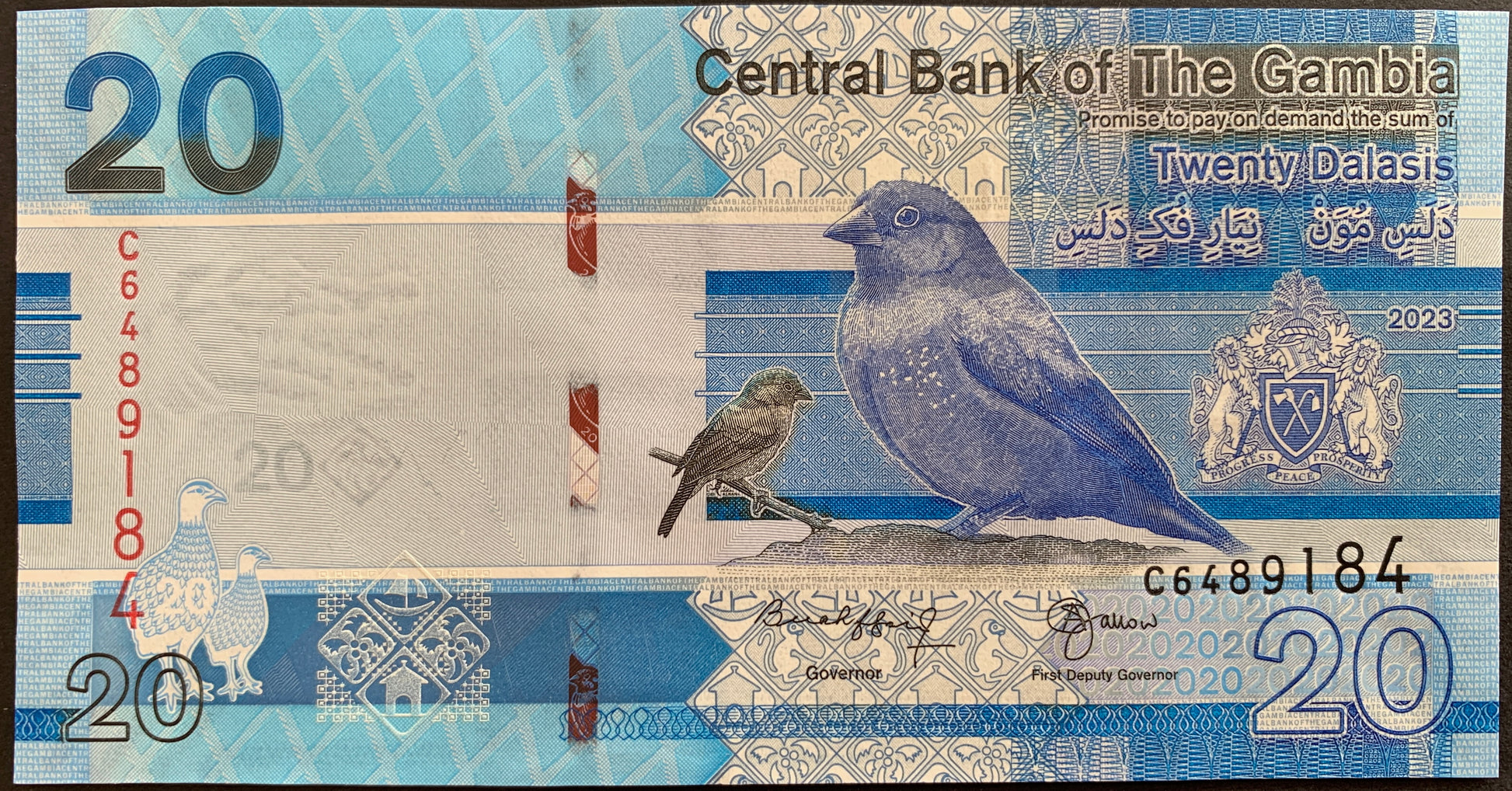 front of The Gambia 20 Dalasis 2023 collectible banknote with bird and coat of arms