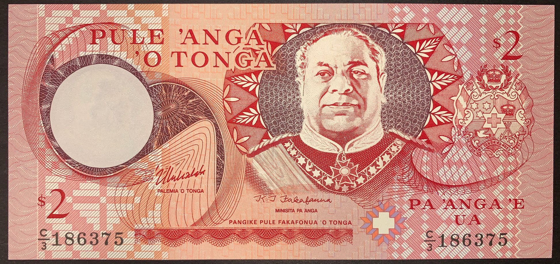 Obverse view of a red and pink Tonga 2 Pa'anga banknote in crisp uncirculated condition. The central-right section displays the detailed portrait of King Tāufaʻāhau Tupou IV in military uniform. The crowned national Coat of Arms is featured on the far right, and a large circular watermark window sits on the left side. The text "PULE 'ANGA O TONGA" is printed at the top left, and the text "PA 'ANGA 'E UA" is printed at the bottom right. The black serial number C/3 186375 is printed on both the lower corners.