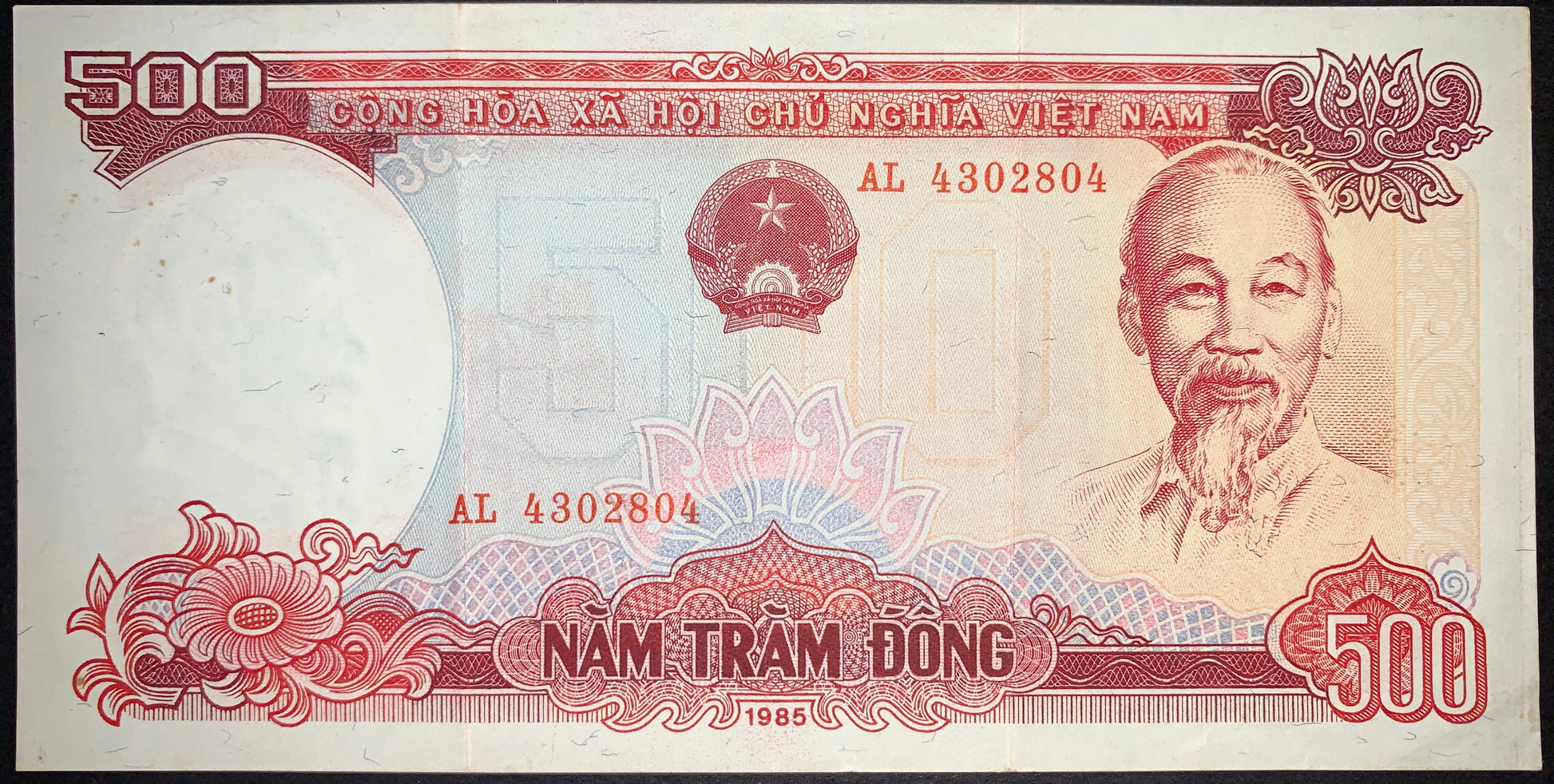 Obverse of an authentic Vietnam 500 Đồng banknote 1985 P-99 featuring a portrait of Ho Chi Minh, the national emblem of Vietnam, intricate security patterns, serial numbers, and denomination inscriptions.