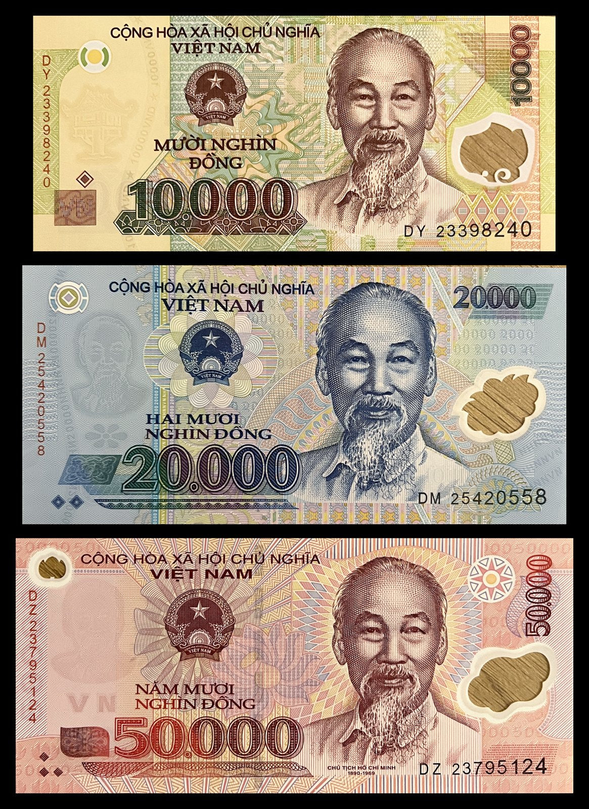 Front view of an uncirculated Vietnam 10,000, 20,000 and 50,000 Dong polymer banknote set featuring Ho Chi Minh and the national emblem with clear windows.