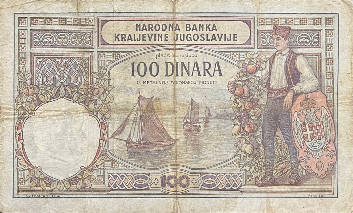 Back view of a 1929 Yugoslavia 100 Dinara banknote showing a young man in Serbian national dress beside the royal Yugoslav coat of arms.