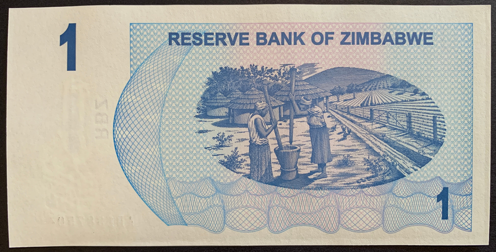 Zimbabwe 1 Dollar 2006 P-37 hyperinflationary banknote with Two women mashing grain near huts