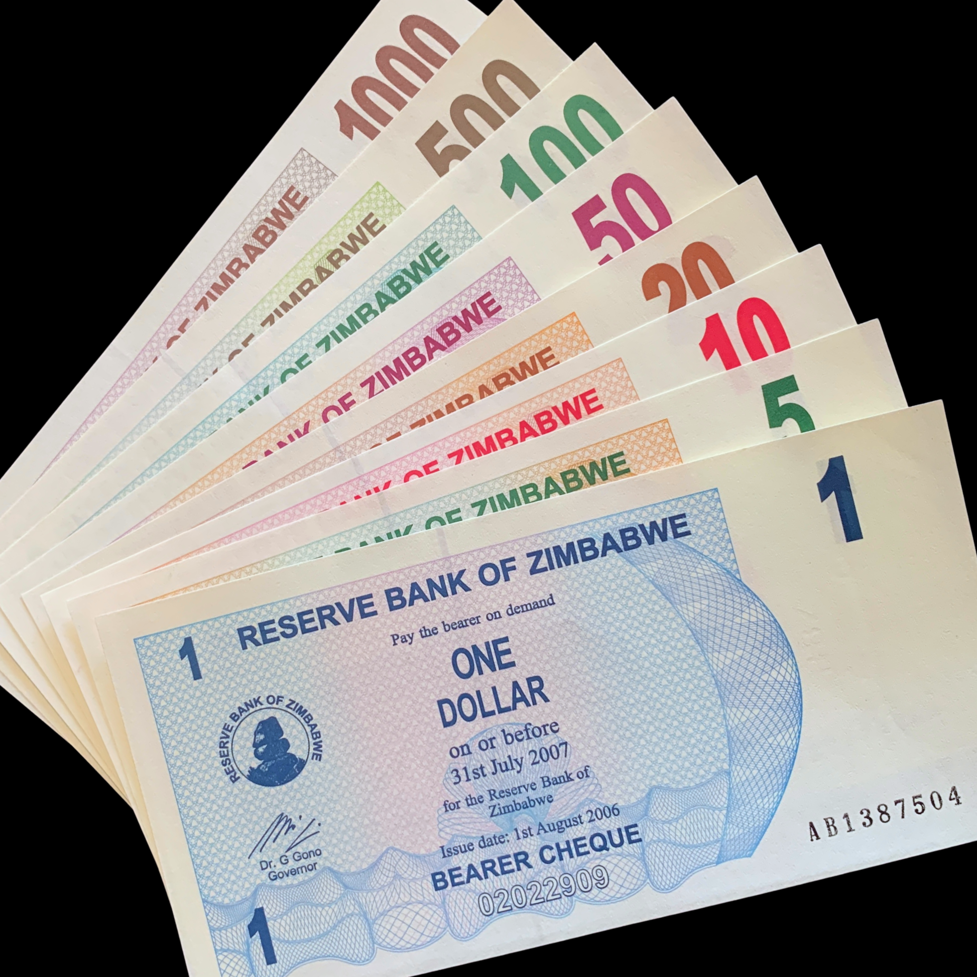 Zimbabwean dollar banknotes from 1 to 1000 dollars on a blackbackground UNC Bearers Cheque Bundle