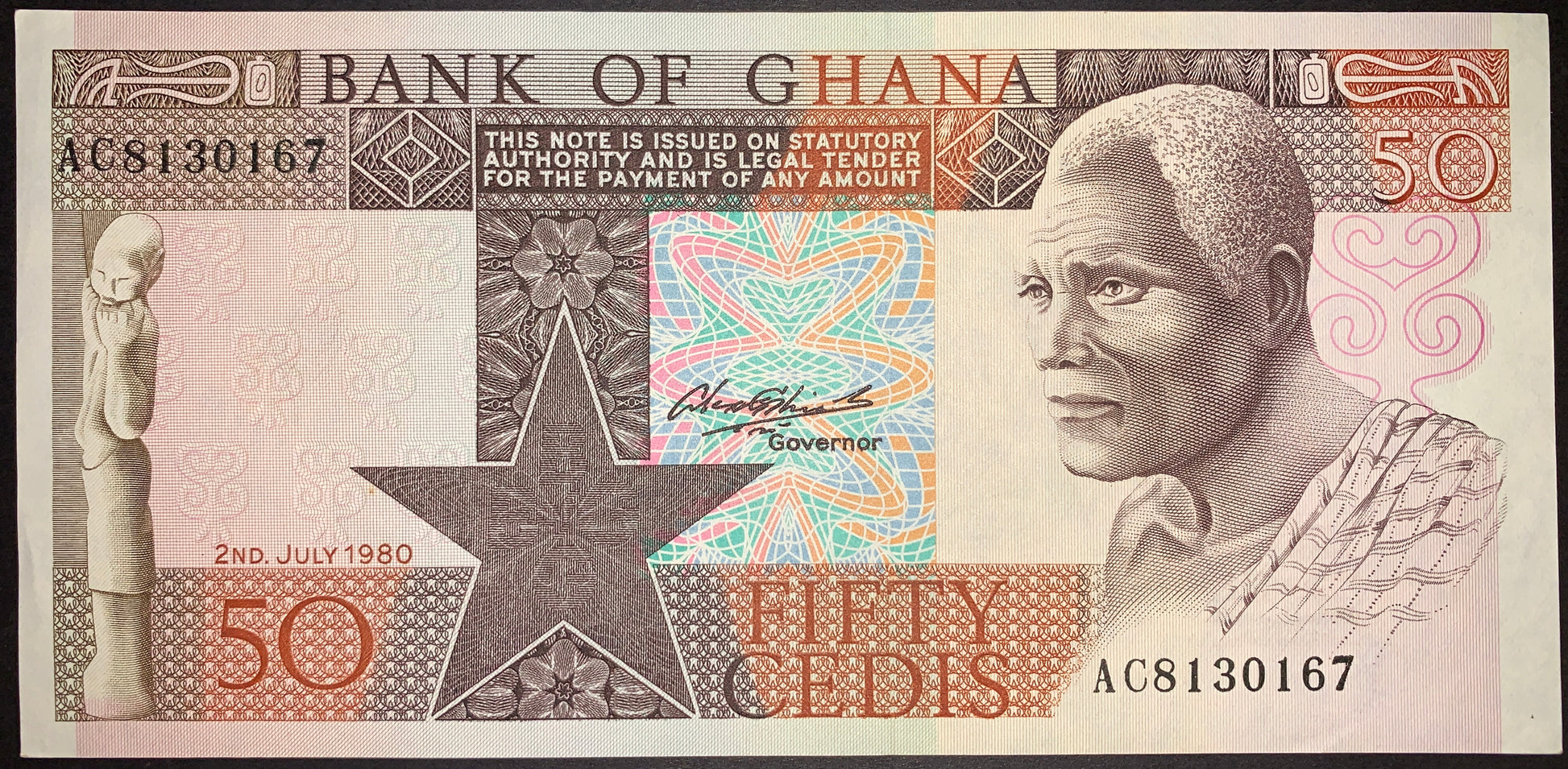 front of Ghana 50 Cedis 1980 P-22b collectible vintage african banknote with portrait of elderly man and statue