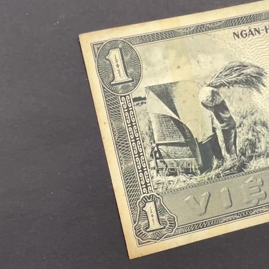 Front view of a circulated 1955 South Vietnam 1 Dong banknote featuring a vintage engraving of a farmer harvesting rice in a field.
