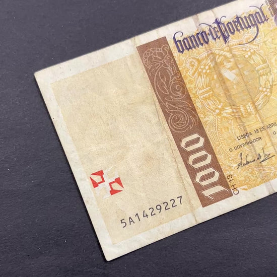 Front view of a circulated 1996 Portugal 1000 Escudos banknote featuring a portrait of explorer Pedro Alvares Cabral and the Cross of the Order of Christ.
