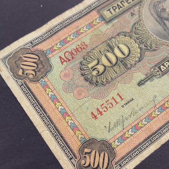 Front view of a circulated 1932 Greece 500 Drachmai banknote featuring a central medallion portrait of the goddess Athena wearing a crested helmet.