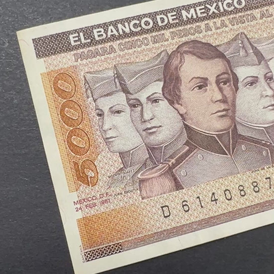 Front view of a crisp, uncirculated 1987 Mexico 5000 Pesos banknote featuring the portraits of the six Niños Héroes (Boy Heroes) and the Mexican flag.