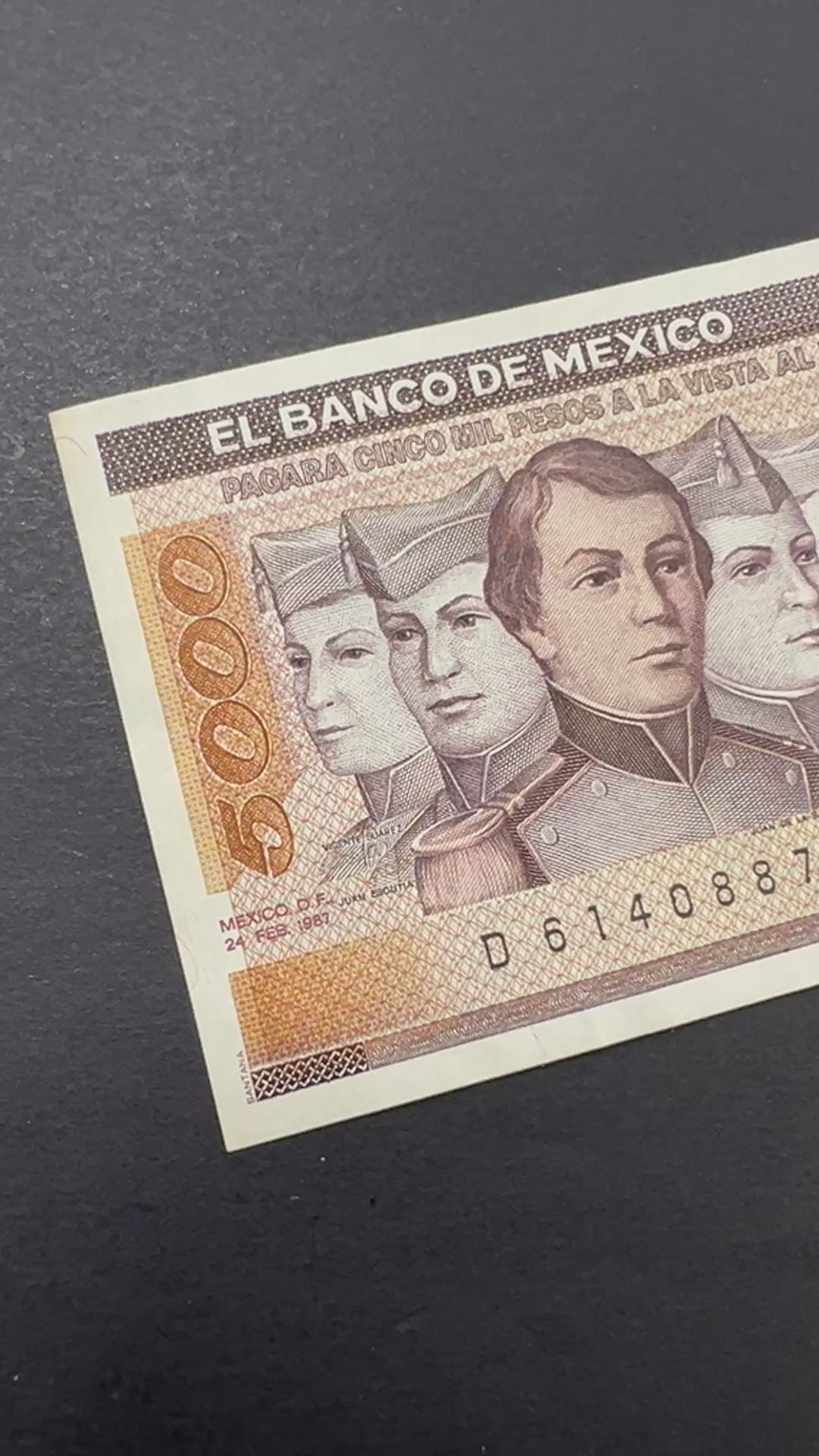 Front view of a crisp, uncirculated 1987 Mexico 5000 Pesos banknote featuring the portraits of the six Niños Héroes (Boy Heroes) and the Mexican flag.