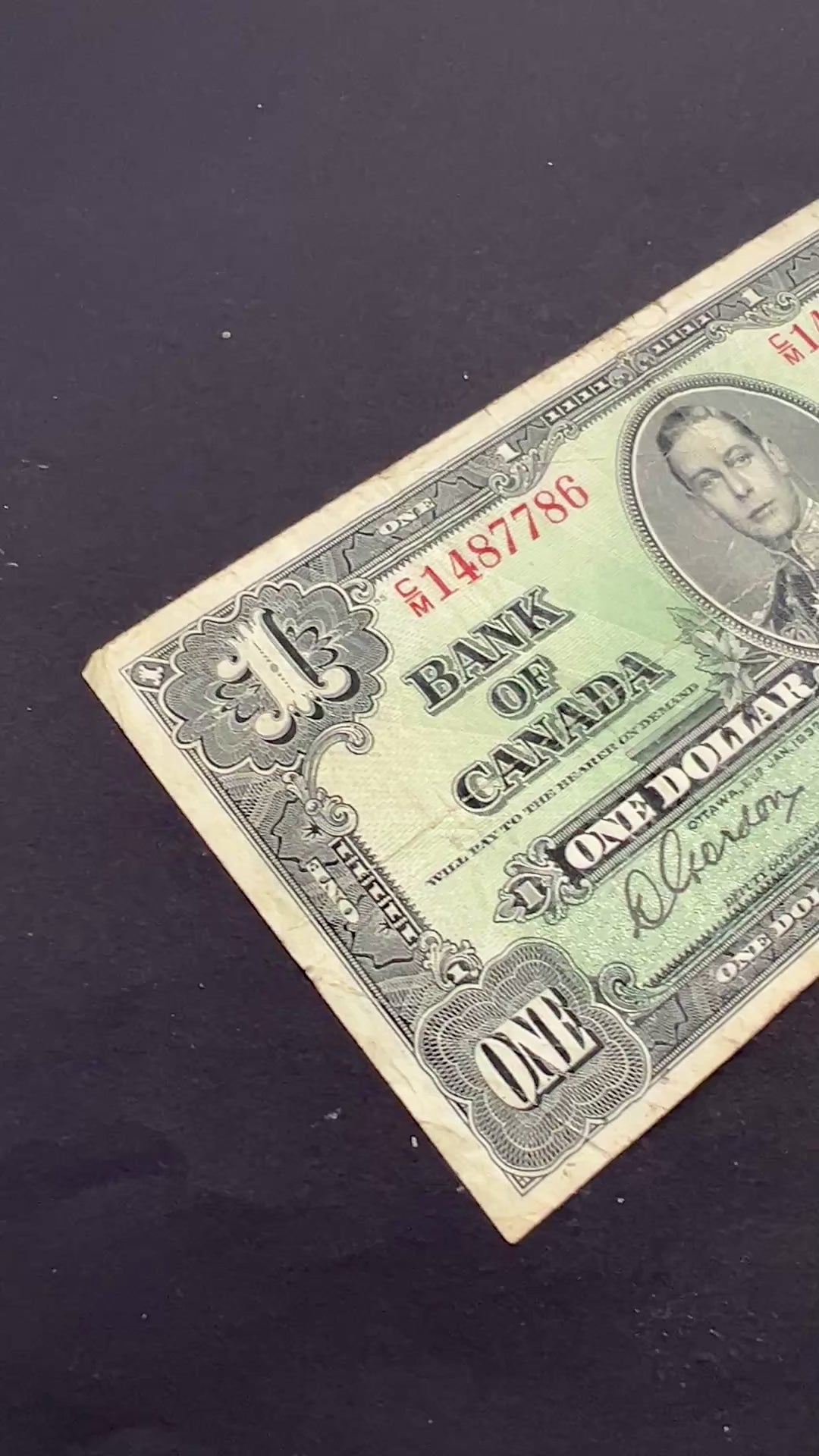 Front view of a vintage 1937 Canada 1 Dollar banknote featuring a portrait of King George VI in military uniform.

