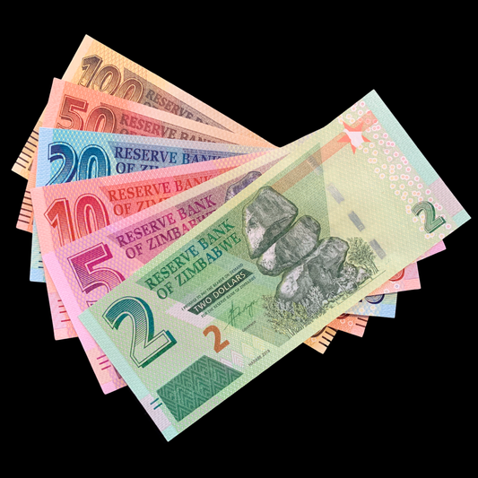 Zimbabwean banknotes of various denominations on a black background
